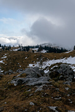 Snowy mountain peak landscape with fog and clouds. Background for travel and winter tourism