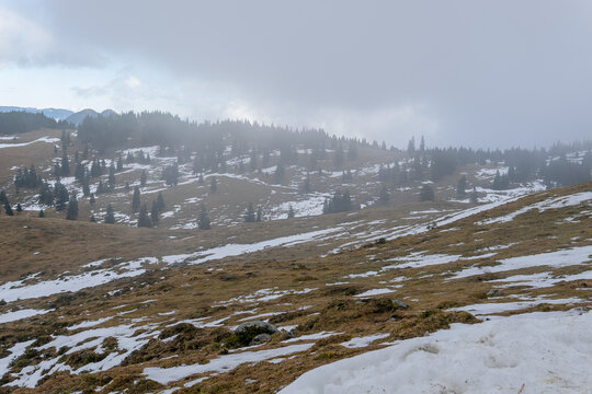 Snowy mountain peak landscape with fog and clouds. Background for travel and winter tourism