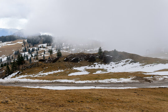 Snowy mountain peak landscape with fog and clouds. Background for travel and winter tourism