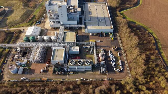 Aerial view of Lenzing Fibers Grimsby revealing a complex of structures, tanks, and pipes contrasting against the surrounding fields, Grimsby, England, United Kingdom.