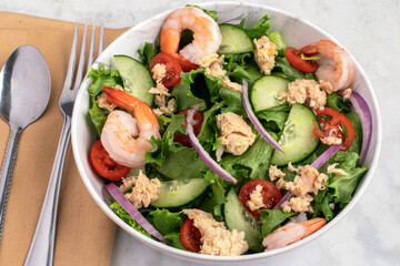  salad top with  shrimp and salad meat