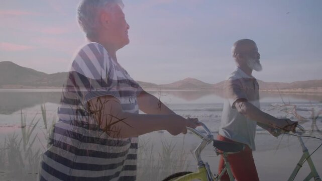 Couple walking with bikes along shore, frames clearing overlay and revealing sunset horizon travel