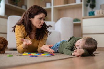 Frustrated mother dealing with child tantrum behavior