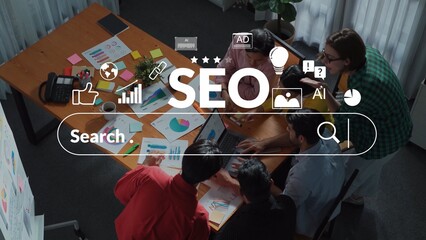 Diverse group brainstorming on SEO strategies in modern office with charts, laptops, and...