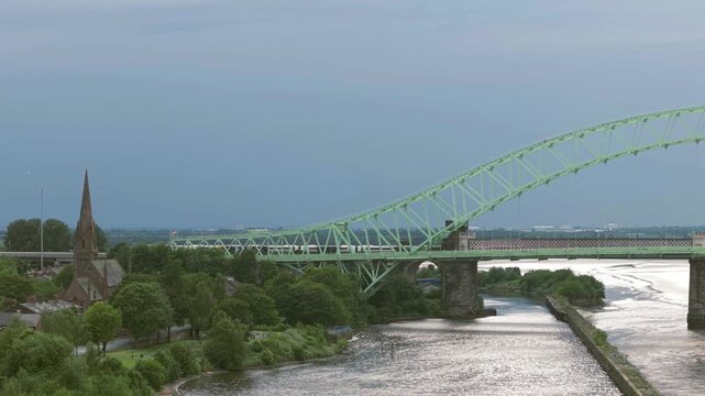 Liverpool, Merseyside, UK, September 09, 2025; aerial 4K video footage of the Silver Jubilee Bridge and Britannia Railway Viaduct over the River Mersey and Manchester Ship Canal, Runcorn, Merseyside
