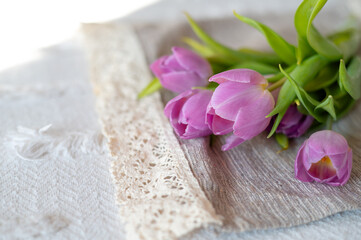 Bouquet of purple tulips on a beige background. Delicate spring floral composition in minimalist style. Concept of spring, freshness and International Women&rsquo;s Day celebration.