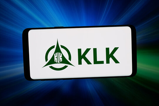 Stuttgart, Germany - 03-02-2026: In this photo illustration, the logo of company Kuala Lumpur Kepong Berhad (KLK) is displayed on a smartphone in front of abstract background on computer screen.