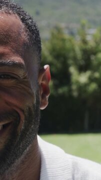 Sunlight shifting hill causing suited group with partial bodies moving and sharing papers for team