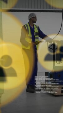 Vertical video: Warehouse worker pressing control and activating pallet, moving crates for shipment