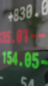 Translucent financial ticker scrolling as camera shifts, revealing palm and updating &yen; &euro; $ values