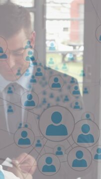Businessman reading card at glass doors, initiating blue avatar overlay linking contacts
