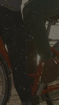 Vertical video: Cyclist on bicycle, mobile burst starting and overlaying floating stars for design