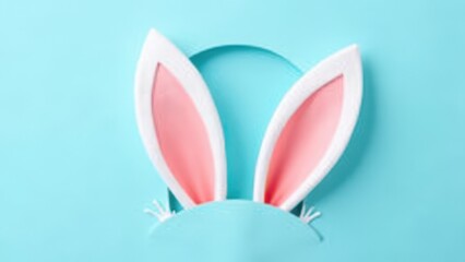 white and pink rabbit ears emerging from cutout hole on pastel blue background playful easter surprise concept of greeting cards, event promotion, seasonal marketing