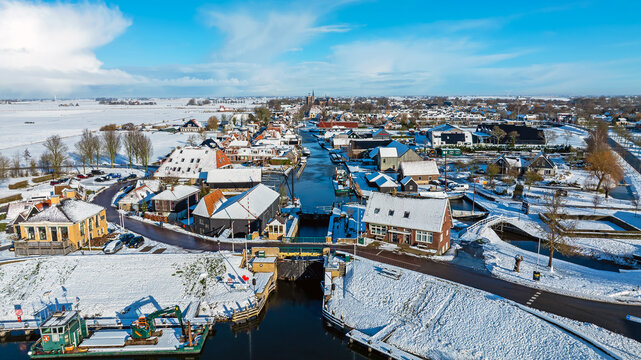 Aerial View of Snowy Historic City with Old Sluice in Foreground