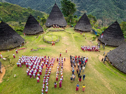 Aerial view of the citizens of Wae Rebo Village celebrating Indonesian Independence day and wearing traditional clothes in East Nusa Tenggara, Flores island, Indonesia