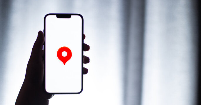 Kaliningrad, Russia - 12.11.2025. Smartphone screen in woman hands displaying logotype of popular application for navigation Yandex Maps. Maps, destination, navigation app