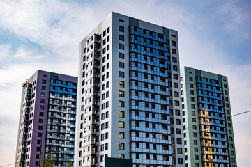 Obraz premium Modern residential towers soaring against urban sky, symbolizing city living and development