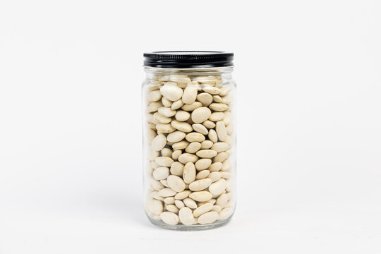 Glass jar filled with large white cannellini beans on a clean white background. Perfect for bulk grocery, health food, and sustainable pantry branding.