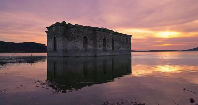 Ruins of medieval abandoned sunken church in dam Zhrebchevo Reservoir, Sliven Region, Bulgaria scenic sunset landscape
