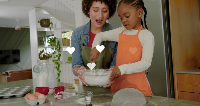 Woman holding bowl, guiding girl whisking for baking at kitchen counter, hearts floating over bowl