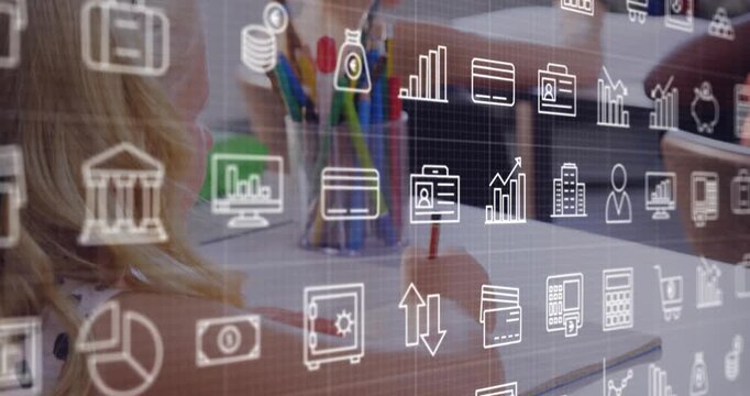 Three girls leaning in, picking pencil and writing in school with overlay on table showing graphs