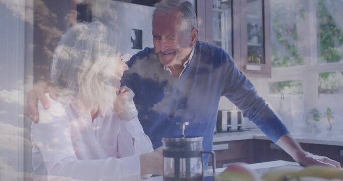 Senior couple, man smiling and leaning, woman holding cup, cloud overlay across couple for health