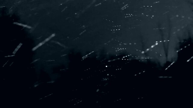 Snowstorm at night, heavy snowfall. Winter hurricane with wind, snow squall.