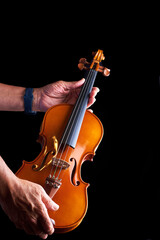Fototapeta premium Person holding wooden violin playing classical music