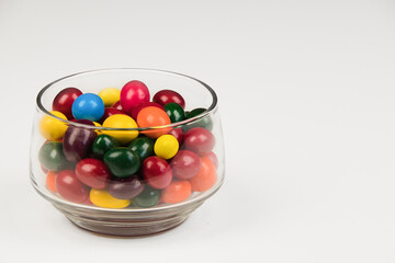Glass bowl full of colorful candy sweets