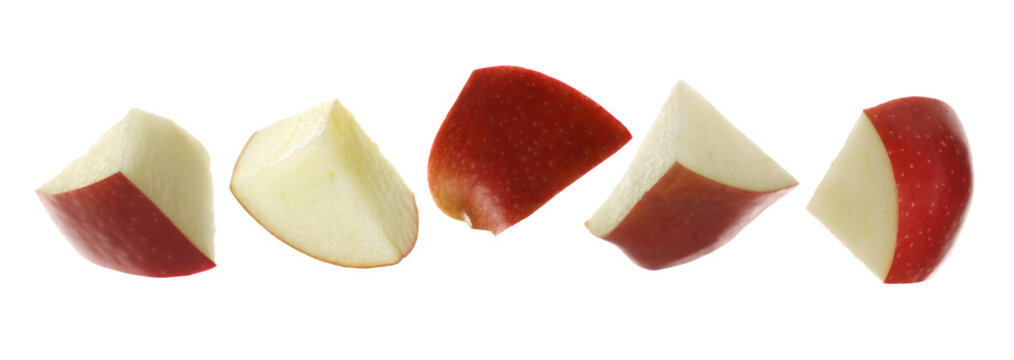 Set red apple fruit pieces flying isolated on white background, clipping path