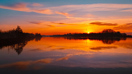 Fototapeta premium Winter sunset or sundowner view with reflections near Plattling, Isar, Deggendorf, Bavaria, Germany