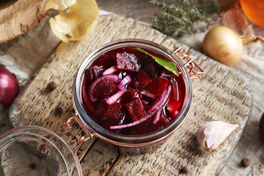 Homemade fermented beet kvass in a glass jar from fresh beetroot, onions, garlic and spices