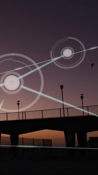 Vertical video: Light streak rising, rings and nodes growing and linking over pier, showing network