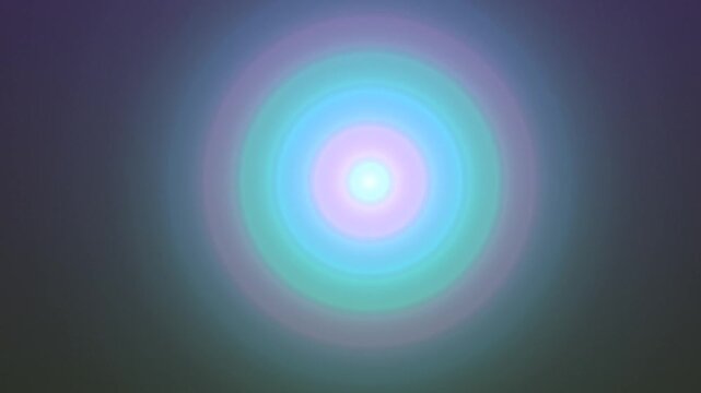 Abstract image of a bright light source with concentric rings of vibrant colors radiating outwards.
