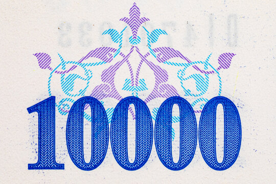 10000 Sum Uzbekistan with the image of national ornaments and fragments of the banknote for design. paper money of Uzbekistan