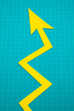 Arrows cut out of colored paper imitating a graphic chart of increase or decrease.

