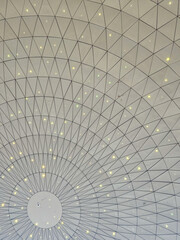 Abstract geometric ceiling pattern of geodesic dome with lights © umut hasanoglu