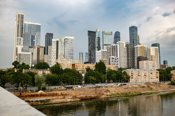 Obraz premium Moscow City skyline with modern skyscrapers, river, and ongoing construction