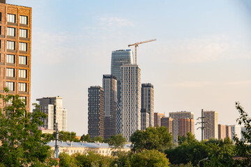 Fototapeta premium Urban skyline with skyscrapers and construction crane symbolizing city development