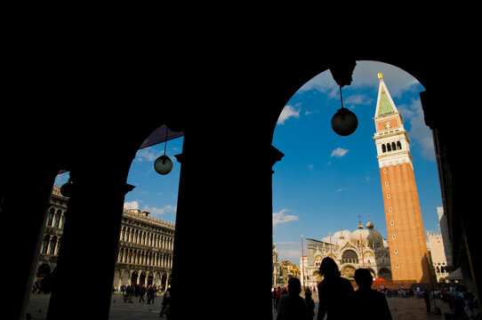 Italy, Veneto, Venice.  St. Mark's Campanile, viewed from covered walkway around  the perimeter of Venice's main square