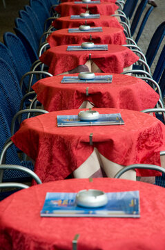 Italy, Veneto, Malcesine, Lago di Garda.  Line of tables at outdoor cafe.
