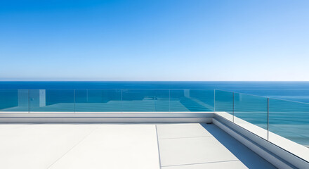 Fototapeta premium Modern white terrace with glass railing overlooking a vast blue ocean and clear sky on a sunny day, perfect for vacation and relaxation.