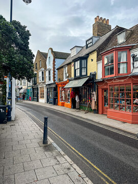 Whitstable, Kent, UK - 09.12.2025. Whitstable High street view, old town, charming shops, cafes in brick buildings. Kent, England. Road. Popular street view small local businesses, shops, restaurants.