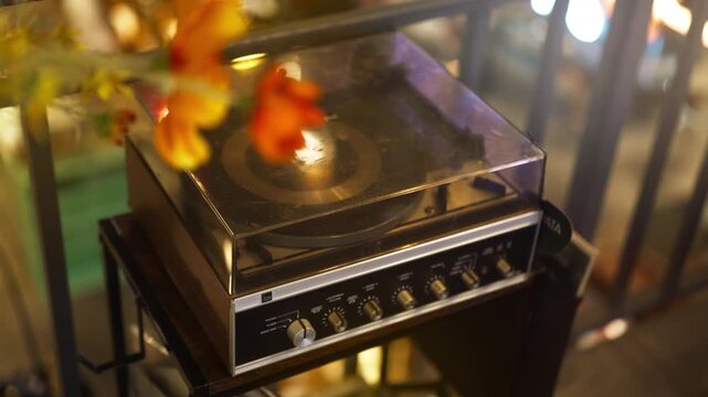 An old turntable in a box sits on a table in soft light.