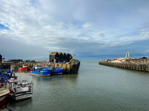 Whitstable, Kent, UK - 09.12.2025. Fishing boats moored at Whitstable harbor in Kent England. Sunny day in Whitstable