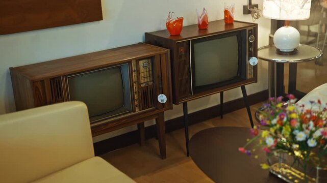 A dark retro styled room with old home appliances and a cathode ray tube TV.