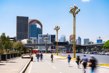 A vibrant cityscape of central Addis Ababa, Ethiopia, showcases modern glass skyscrapers and bustling urban activity near Meskel Square under a clear sky.