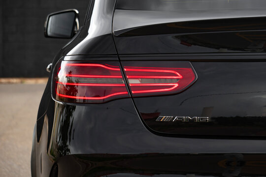 Black Mercedes GLE 63 tail light and AMG badge close up, High performance luxury SUV rear end logo and break lights