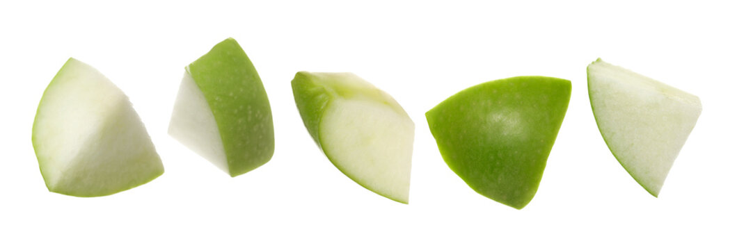Set green apple fruit pieces flying isolated on white background, clipping path
