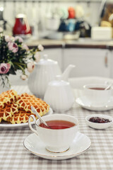 Fototapeta premium breakfast with tea and a homemade Belgian waffles